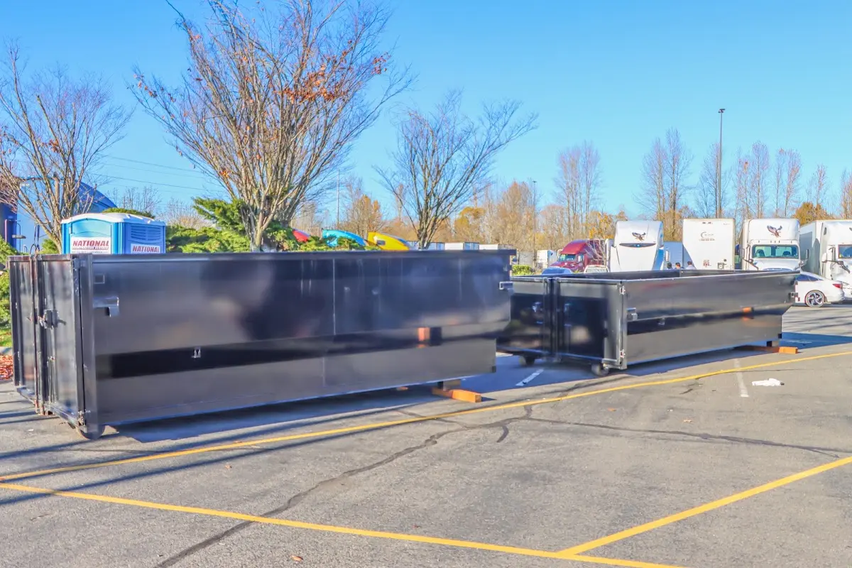 Professional dumpster rental service with roll-off container on residential driveway in Sussex